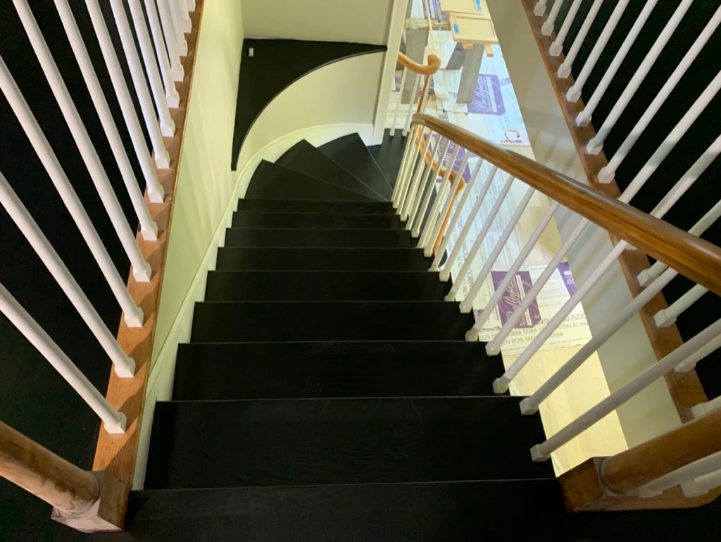 Dark stained stairs with white railings