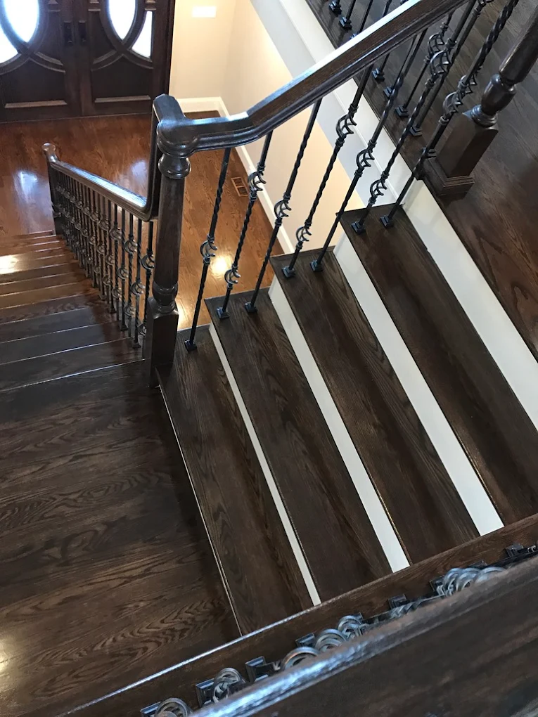 Elegant dark stair installation with railings
