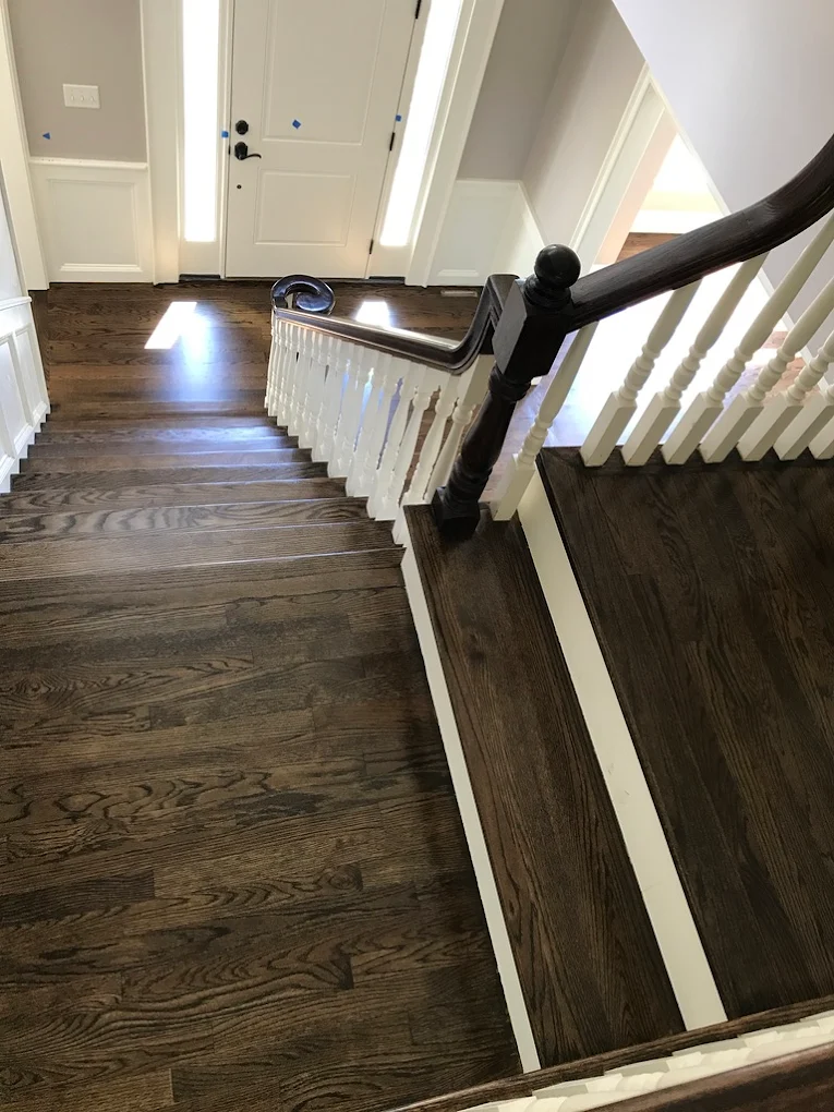 Staircase entryway with white railings