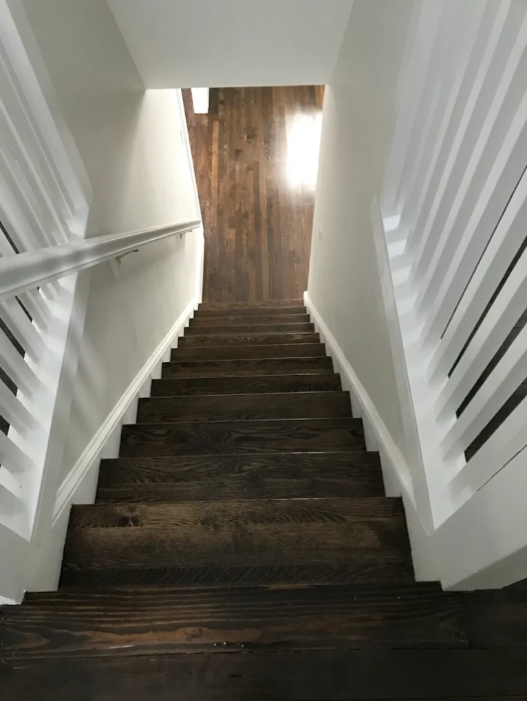 Staircase with dark treads and landing